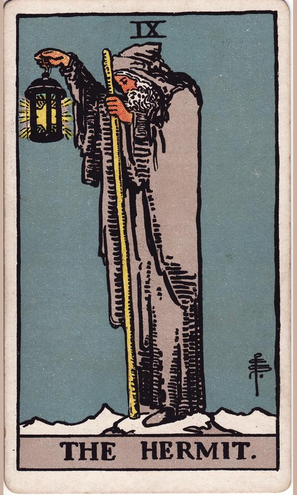 The Hermit — a cloaked figure on a mountain top, holding a lantern out over the dark